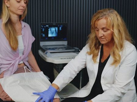 Karen Rea performing an ultrasound-guided knee injection on a patient